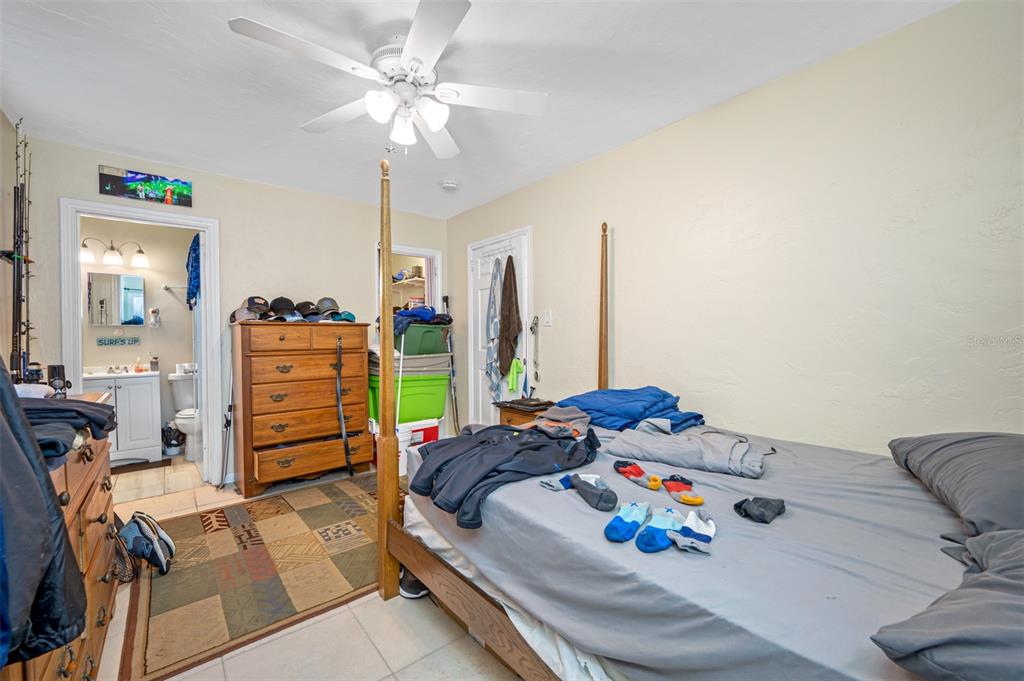 14111 West Parsley Drive Madeira Beach, FL 33708 - Photo 76 of 99 a bedroom with furniture and a closet