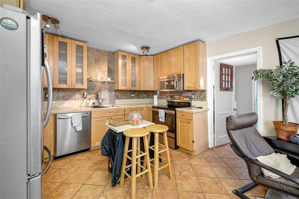 14111 West Parsley Drive Madeira Beach, FL 33708 - Photo 82 of 99 a kitchen with a stove a table and chairs in it