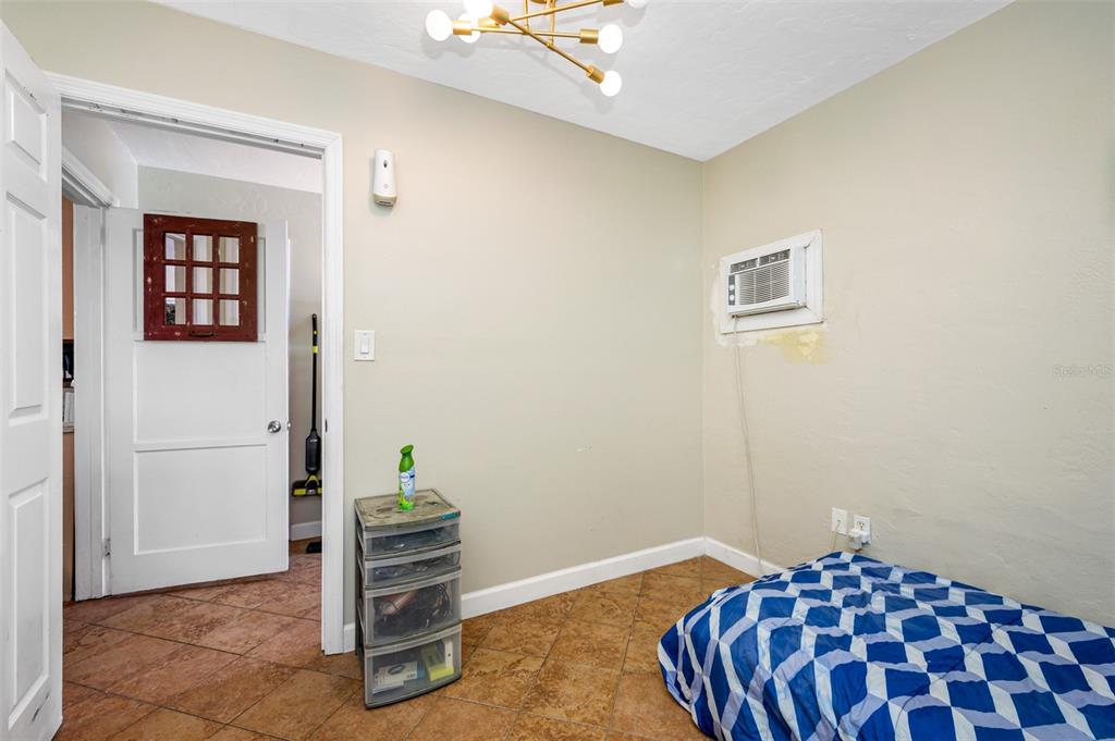 14111 West Parsley Drive Madeira Beach, FL 33708 - Photo 91 of 99 a bedroom with a bed and a view of bathroom