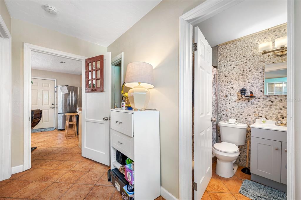 14111 West Parsley Drive Madeira Beach, FL 33708 - Photo 94 of 99 a bathroom with a sink a toilet and shower curtain