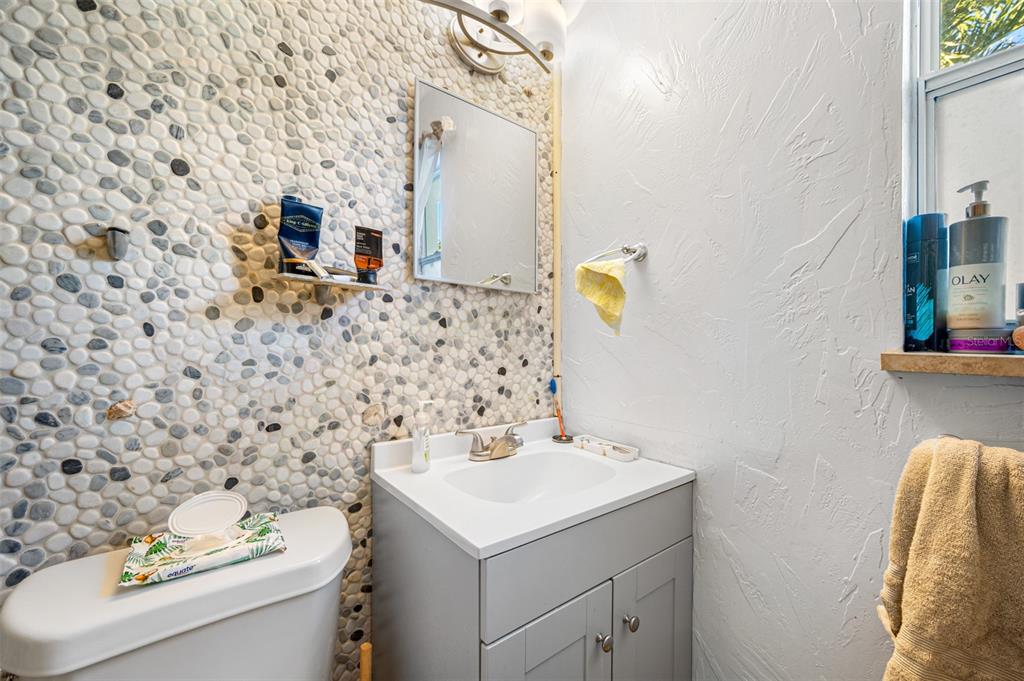 14111 West Parsley Drive Madeira Beach, FL 33708 - Photo 97 of 99 a bathroom with a sink and a mirror