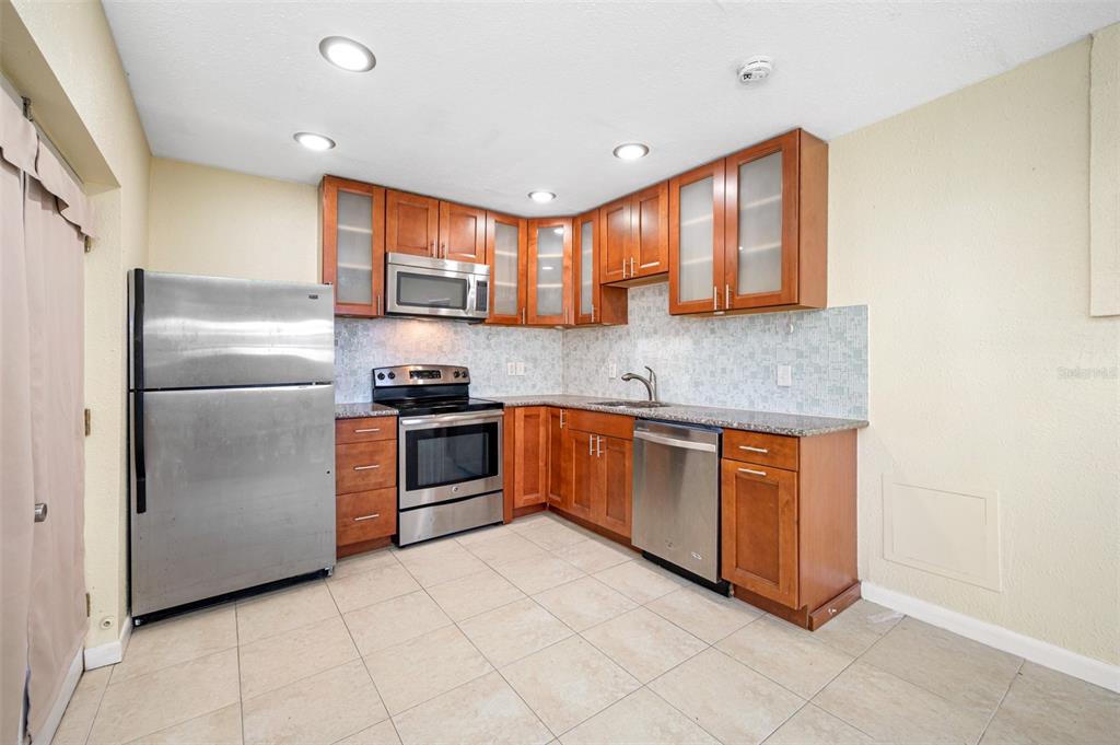 14111 West Parsley Drive Madeira Beach, FL 33708 - Photo 98 of 99 a kitchen with stainless steel appliances granite countertop a refrigerator and a sink