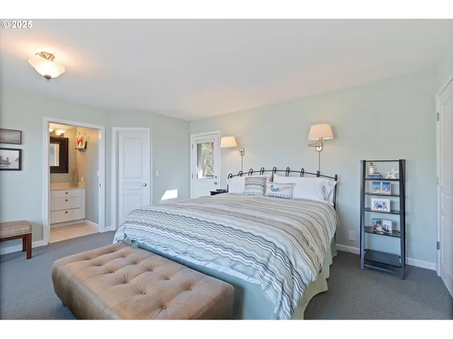 a bedroom with furniture and a large window