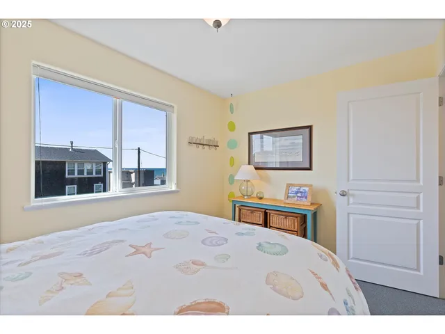 a living room with furniture a floor to ceiling window and a flat screen tv