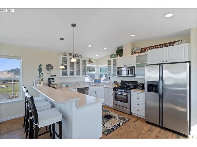a kitchen with stainless steel appliances a refrigerator stove and sink