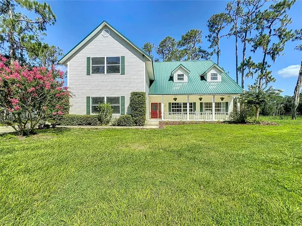a front view of house with yard and green space
