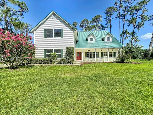 a front view of house with yard and green space