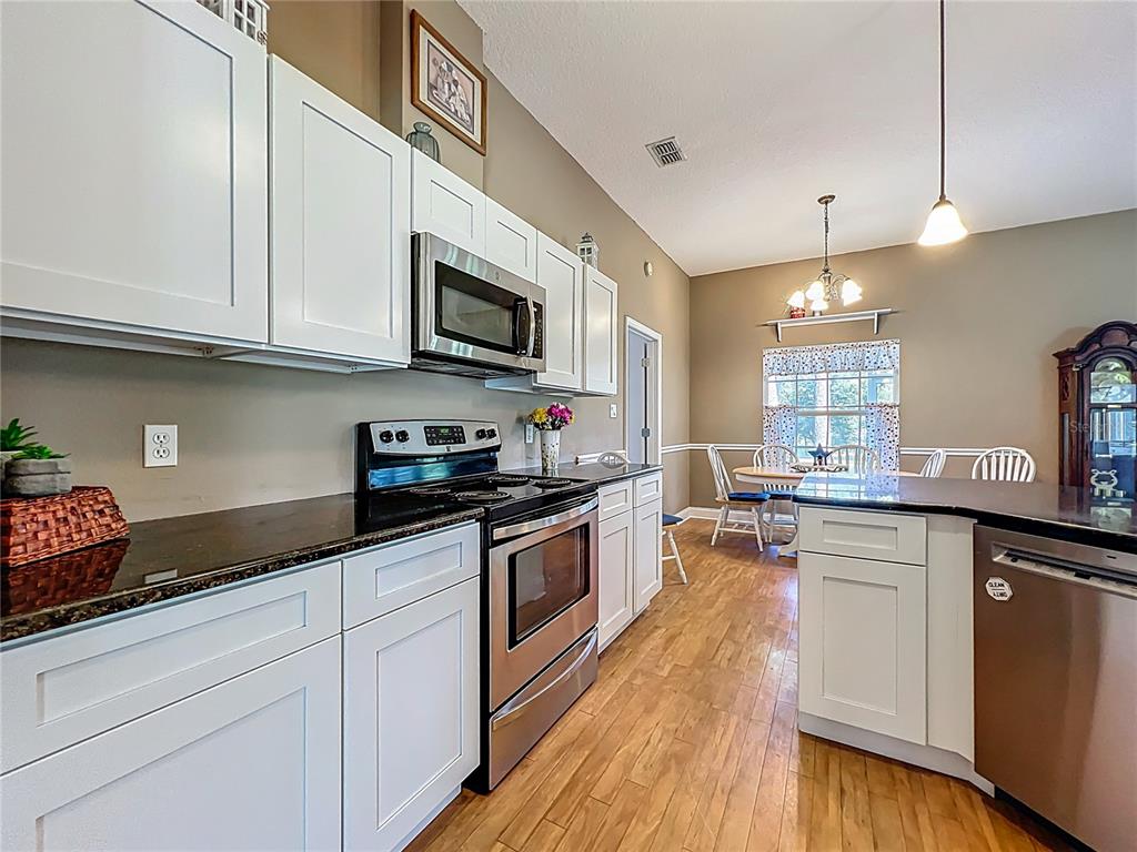 10222 Rockridge Road Lakeland, FL 33810 - Photo 12 of 39 a kitchen with stainless steel appliances granite countertop a sink a stove and cabinets