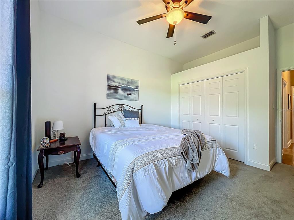 10222 Rockridge Road Lakeland, FL 33810 - Photo 28 of 39 a bedroom with a bed and a chandelier