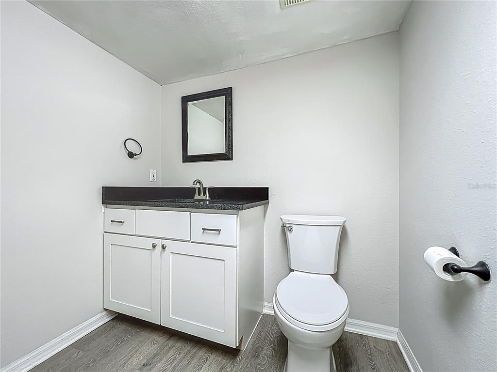 10222 Rockridge Road Lakeland, FL 33810 - Photo 35 of 39 a bathroom with a toilet sink and mirror