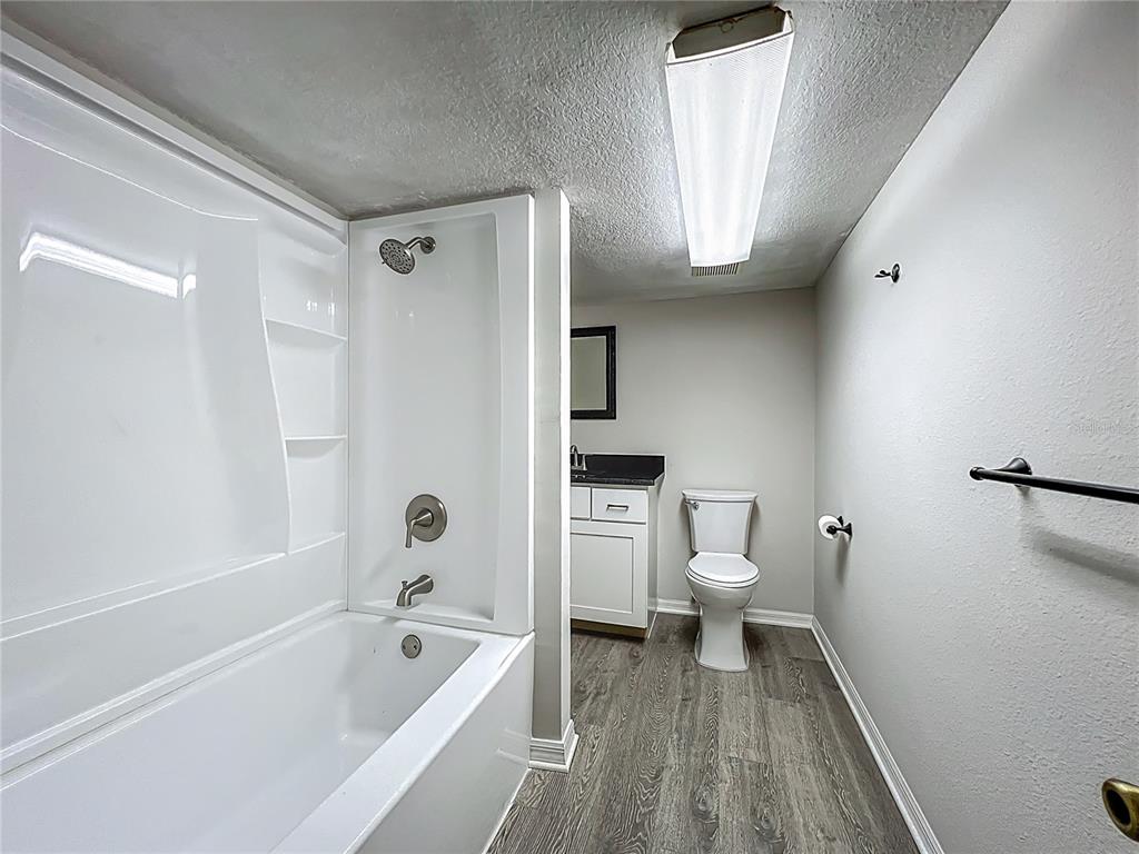 10222 Rockridge Road Lakeland, FL 33810 - Photo 36 of 39 a bathroom with a bathtub toilet and a shower
