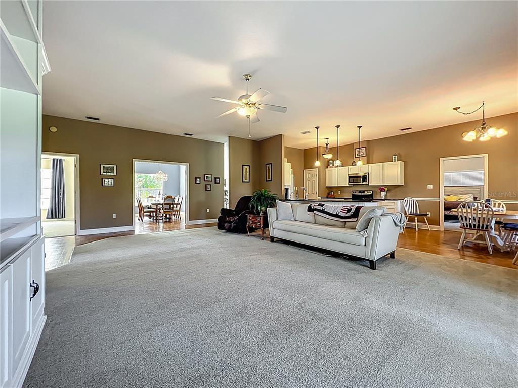 10222 Rockridge Road Lakeland, FL 33810 - Photo 8 of 39 a living room with furniture and a chandelier