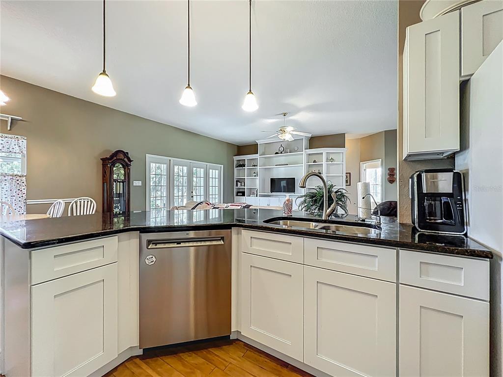 10222 Rockridge Road Lakeland, FL 33810 - Photo 10 of 39 a kitchen with granite countertop a sink a counter space appliances and cabinets