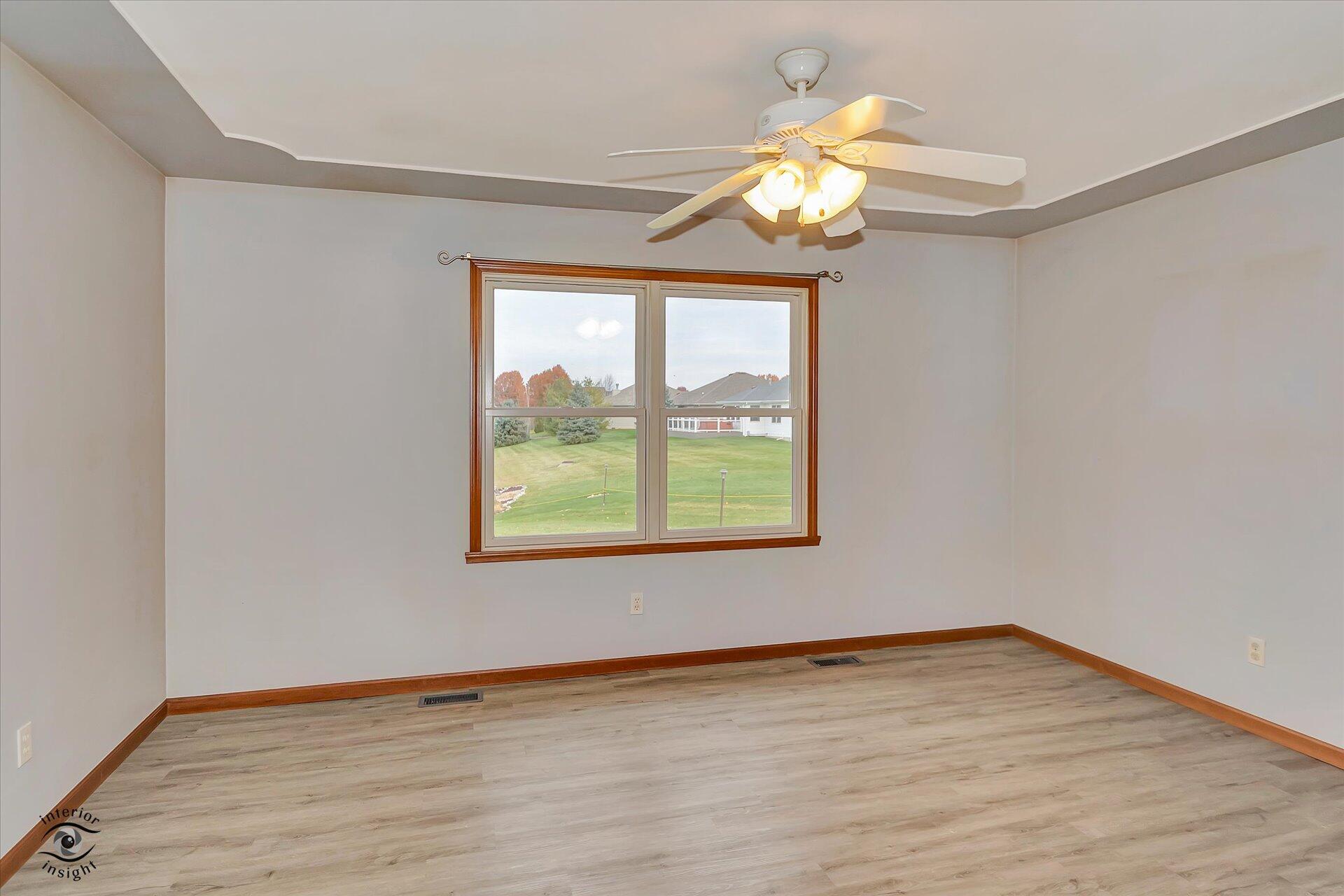 7646 Amanda's Way Crown Point, IN 46307 - Photo 11 of 26 a view of an empty room with wooden floor and a window