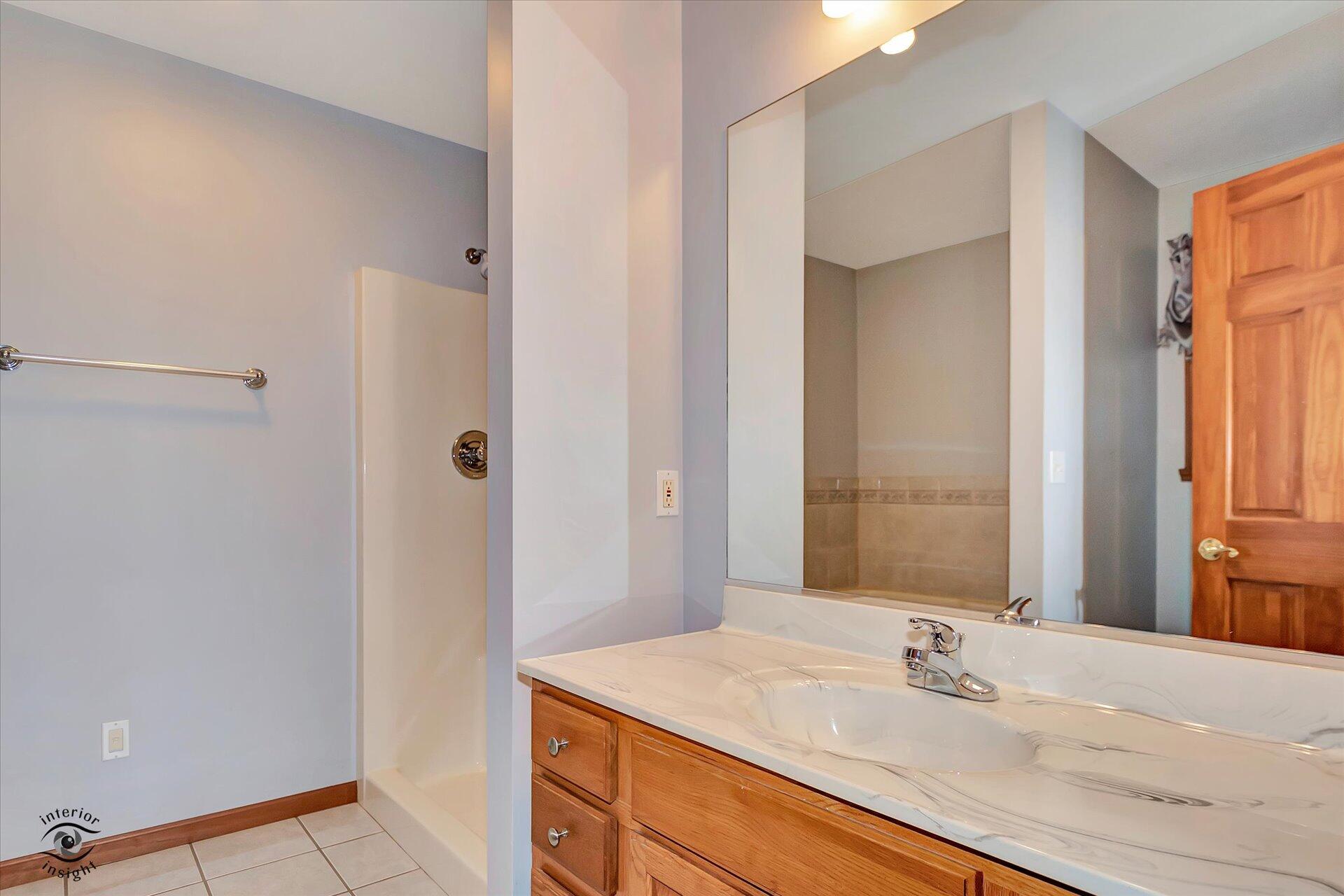 7646 Amanda's Way Crown Point, IN 46307 - Photo 14 of 26 a bathroom with a sink and a mirror