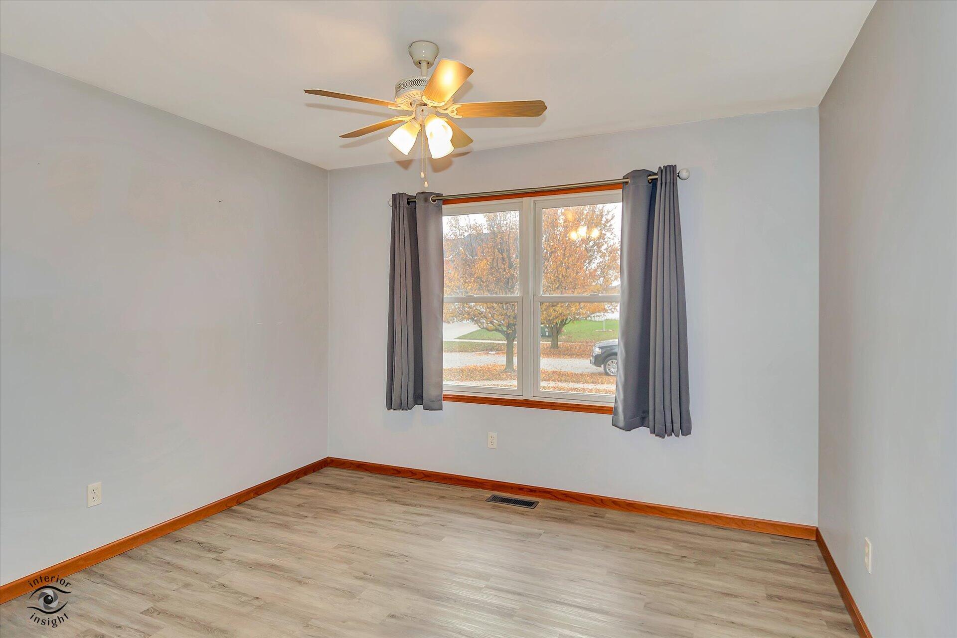 7646 Amanda's Way Crown Point, IN 46307 - Photo 18 of 26 a view of an empty room with wooden floor and a window