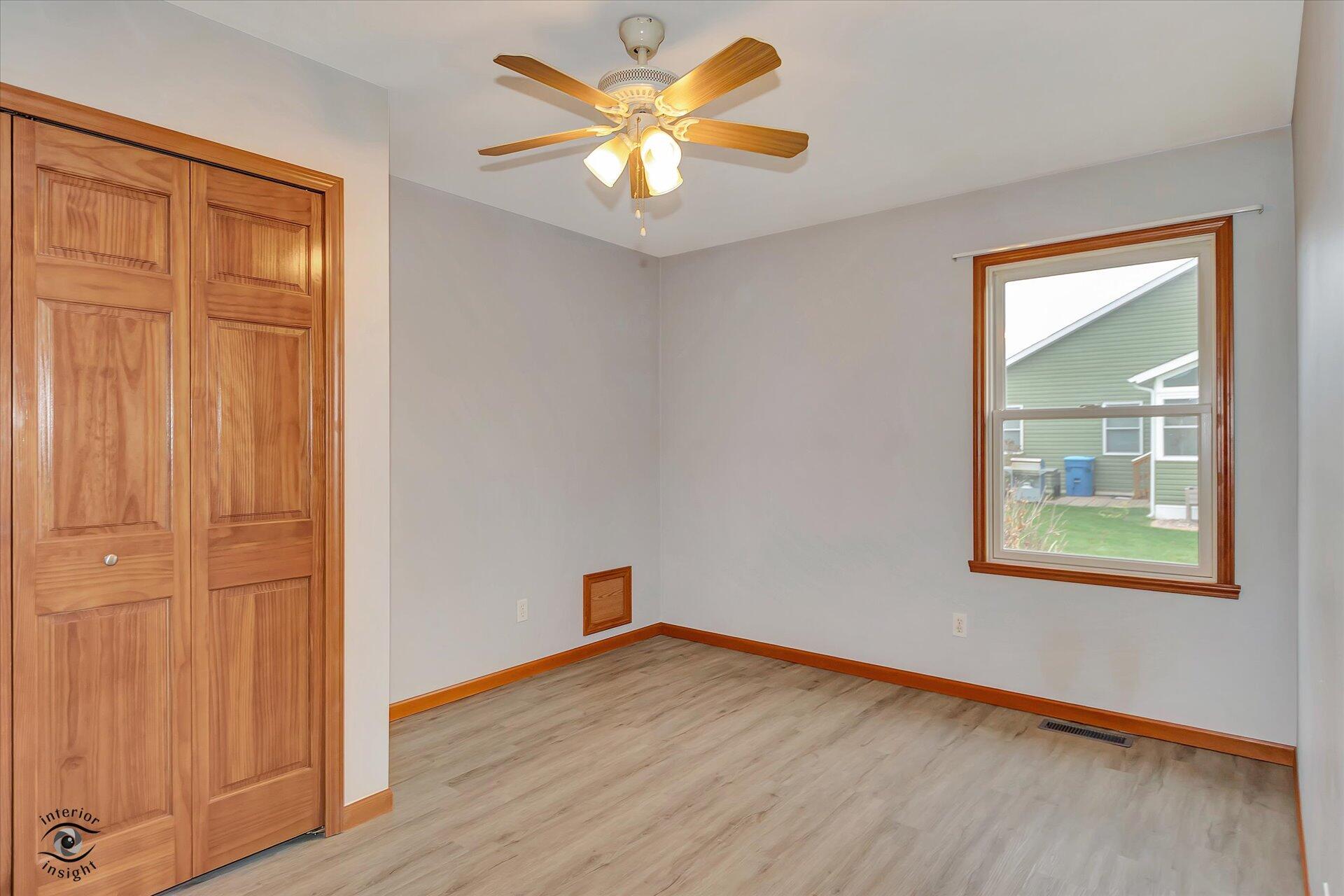 7646 Amanda's Way Crown Point, IN 46307 - Photo 19 of 26 an empty room with a window and a ceiling fan