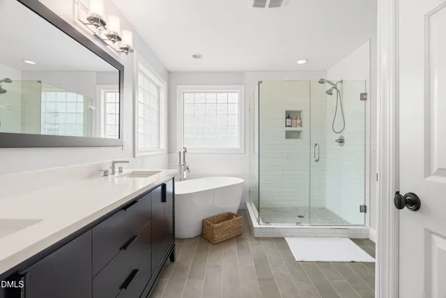 a bathroom with a tub sink and mirror