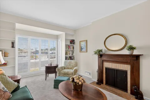 a living room with furniture a rug and a fireplace