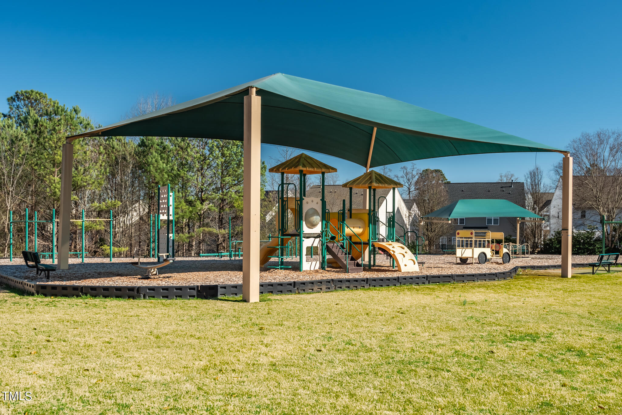 5324 Eagle Trace Drive Raleigh, NC 27604 - Photo 25 of 26 a view of a swimming pool with a table and chairs under an umbrella