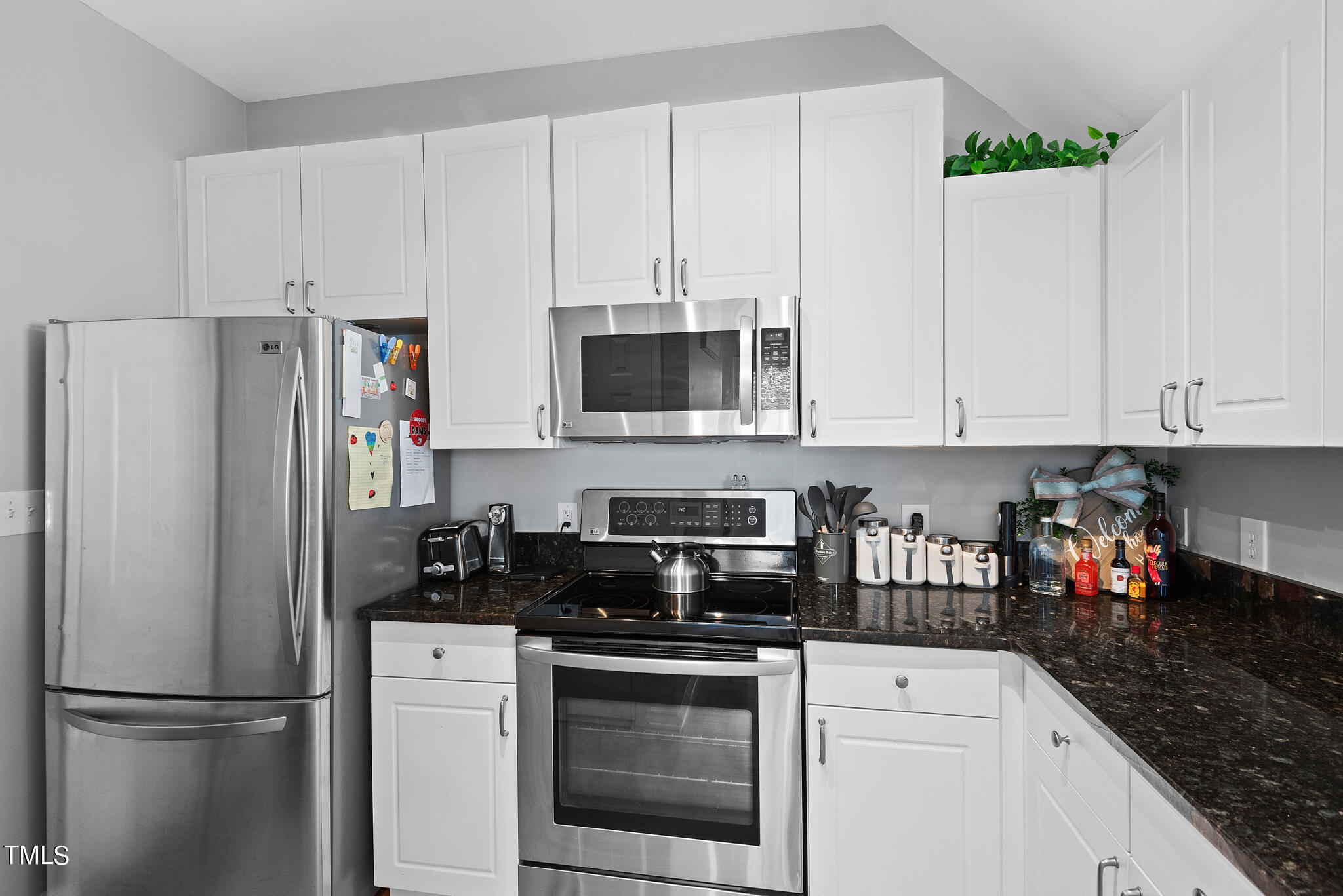 5324 Eagle Trace Drive Raleigh, NC 27604 - Photo 5 of 26 a kitchen with stainless steel appliances granite countertop white cabinets sink and a refrigerator