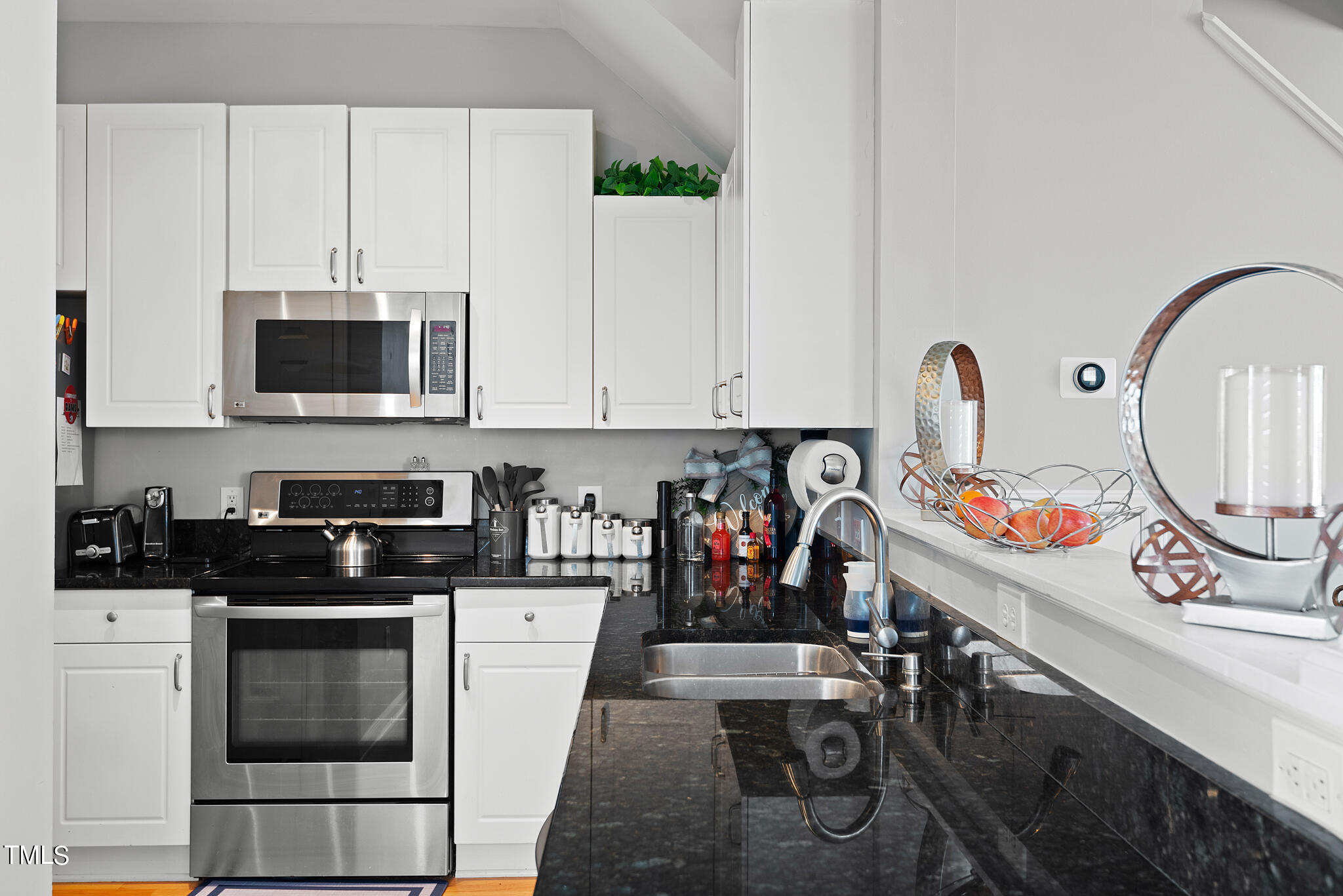 5324 Eagle Trace Drive Raleigh, NC 27604 - Photo 6 of 26 a kitchen with stainless steel appliances a stove a sink and a microwave
