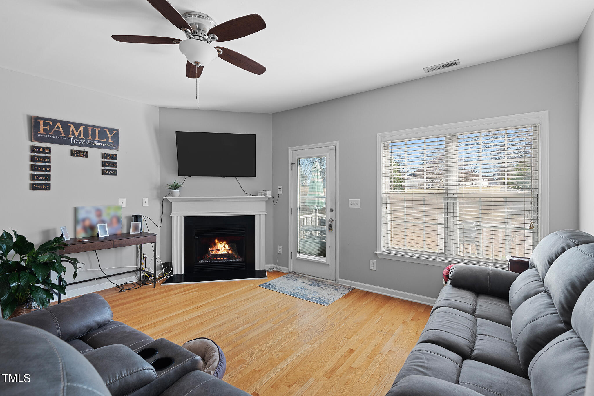 5324 Eagle Trace Drive Raleigh, NC 27604 - Photo 10 of 26 a living room with furniture a flat screen tv and a fireplace
