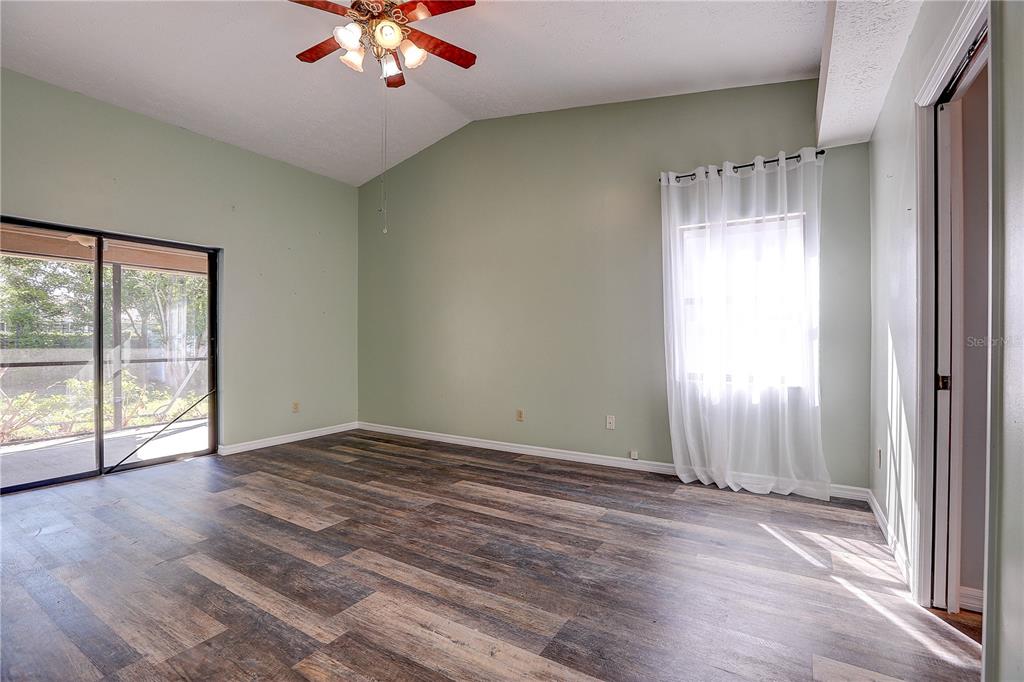 1418 Buckner Road Valrico, FL 33596 - Photo 10 of 37 wooden floor in an empty room with a window