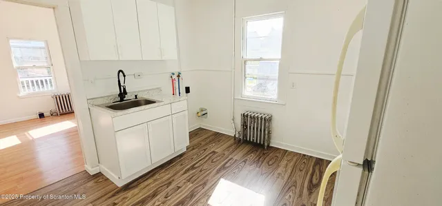 a kitchen with a sink stove and cabinets
