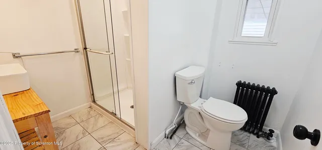 a white toilet sitting next to a bathroom sink