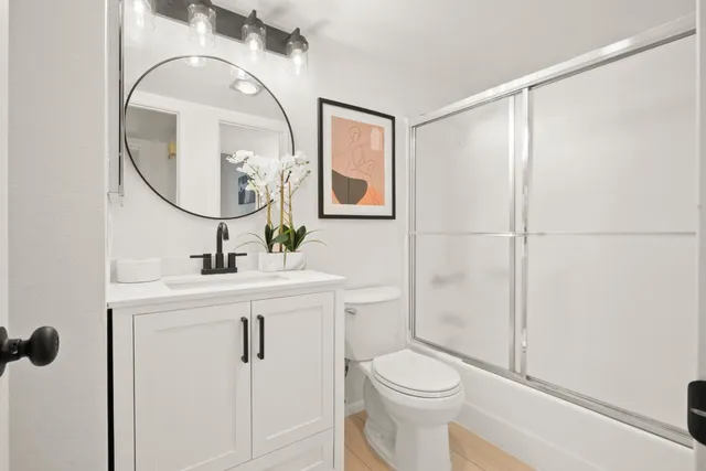 a bathroom with a toilet a sink and a mirror