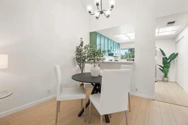 a view of a dining room with furniture and a chandelier