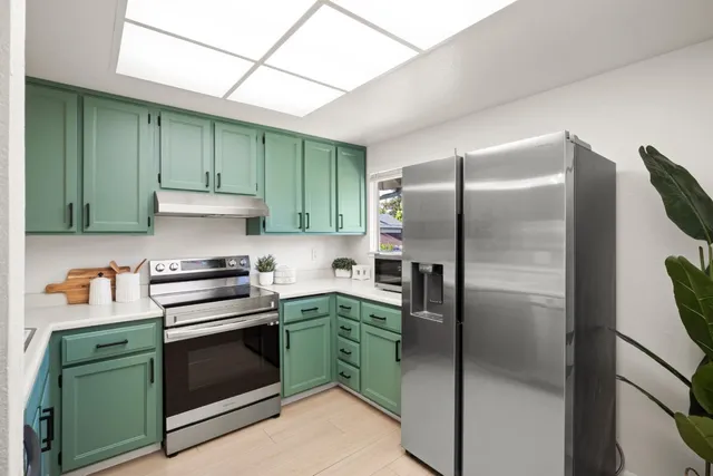 a kitchen with cabinets and stainless steel appliances