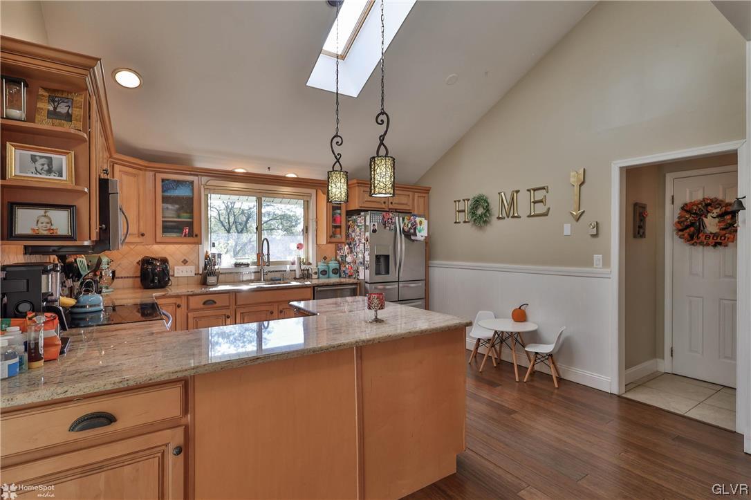 4175 Sherry Hill Road Hellertown, PA 18055 - Photo 15 of 50 a very nice looking kitchen with granite countertop a sink and dishwasher a stove with wooden floor