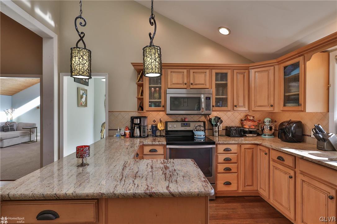 4175 Sherry Hill Road Hellertown, PA 18055 - Photo 18 of 50 a kitchen with stainless steel appliances granite countertop a sink stove and refrigerator