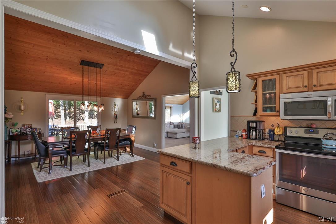 4175 Sherry Hill Road Hellertown, PA 18055 - Photo 19 of 50 a view of a dining room and livingroom with furniture wooden floor a chandelier