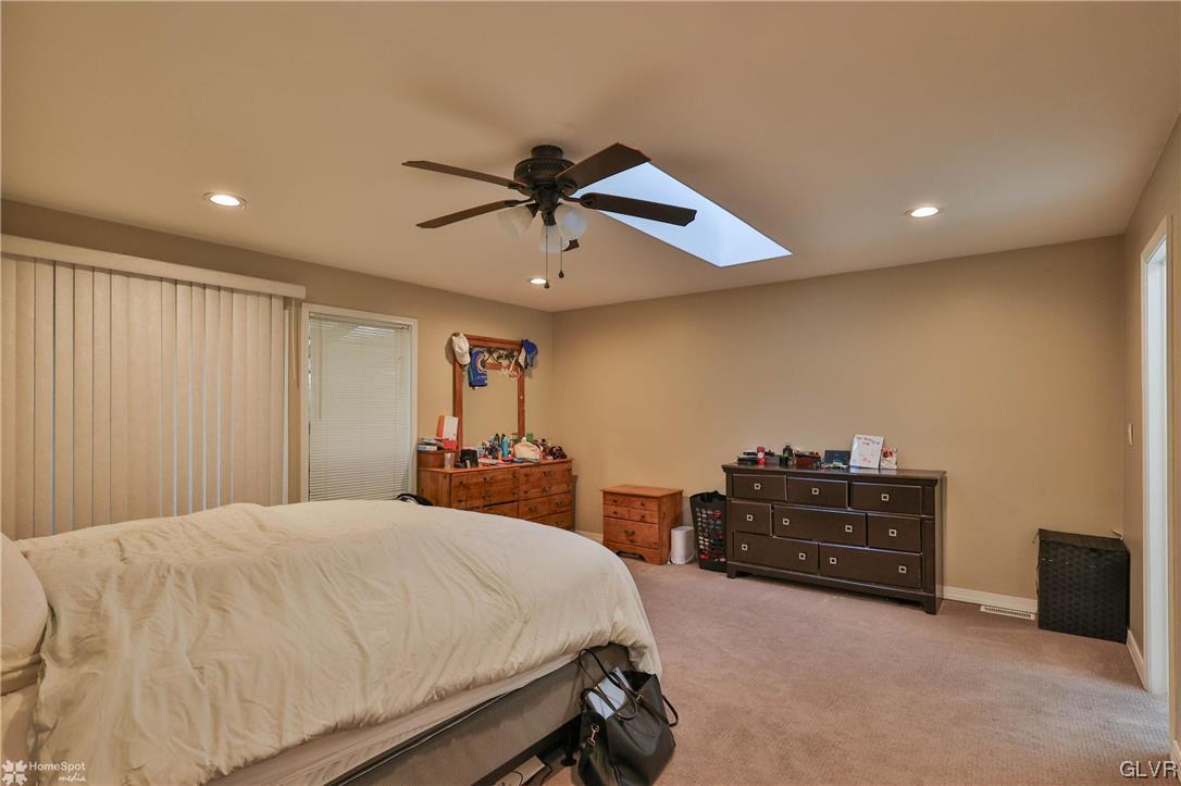 4175 Sherry Hill Road Hellertown, PA 18055 - Photo 30 of 50 a bed room with a bed and a chandelier