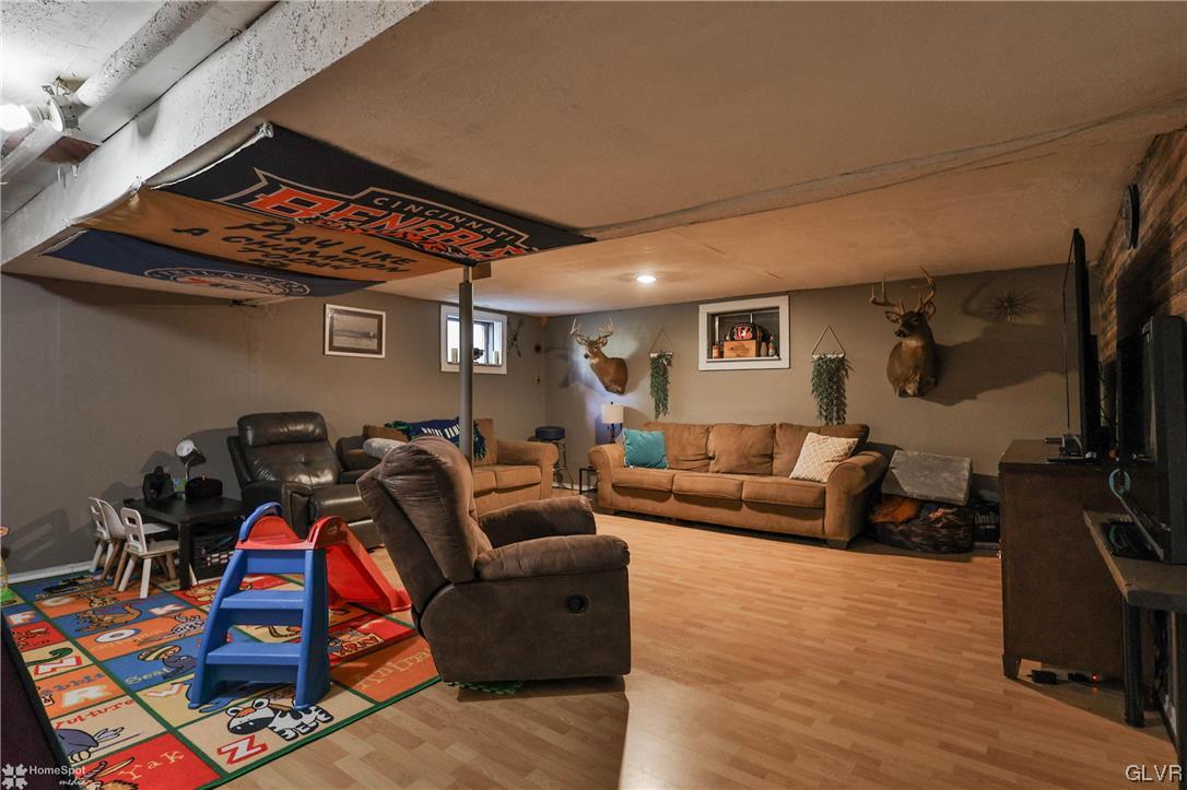 4175 Sherry Hill Road Hellertown, PA 18055 - Photo 42 of 50 a living room with furniture a flat screen tv and gym equipment