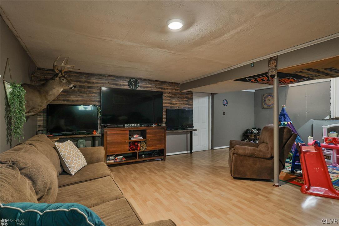 4175 Sherry Hill Road Hellertown, PA 18055 - Photo 43 of 50 a living room with furniture and a flat screen tv