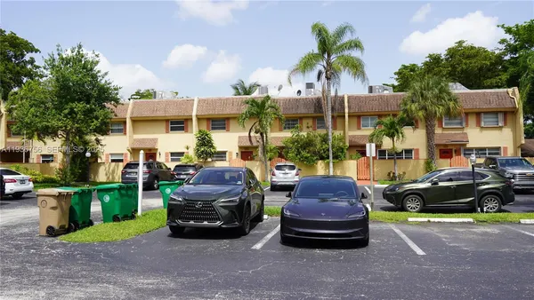 a couple of cars parked in front of a house
