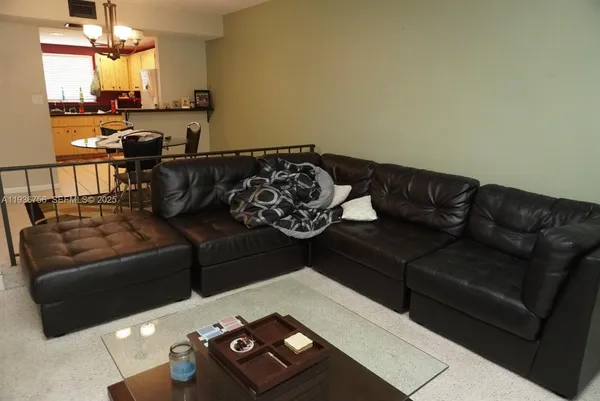 a bedroom with a bed and a flat tv screen on dresser