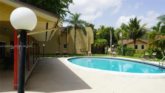 a view of swimming pool with outdoor seating and yard