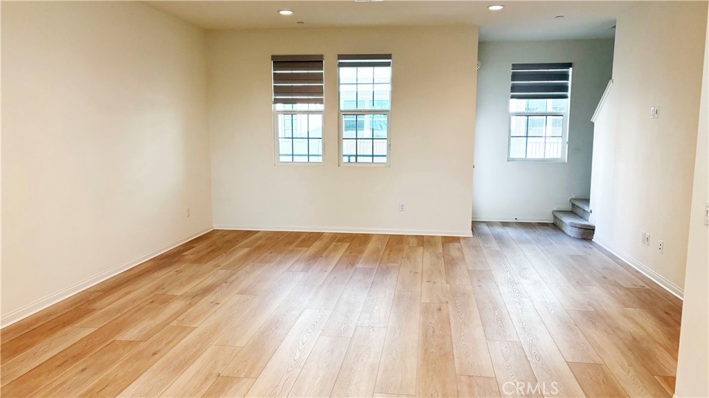6972 Sagebrush Circle Buena Park, CA 90621 - Photo 2 of 7 an empty room with wooden floor and windows