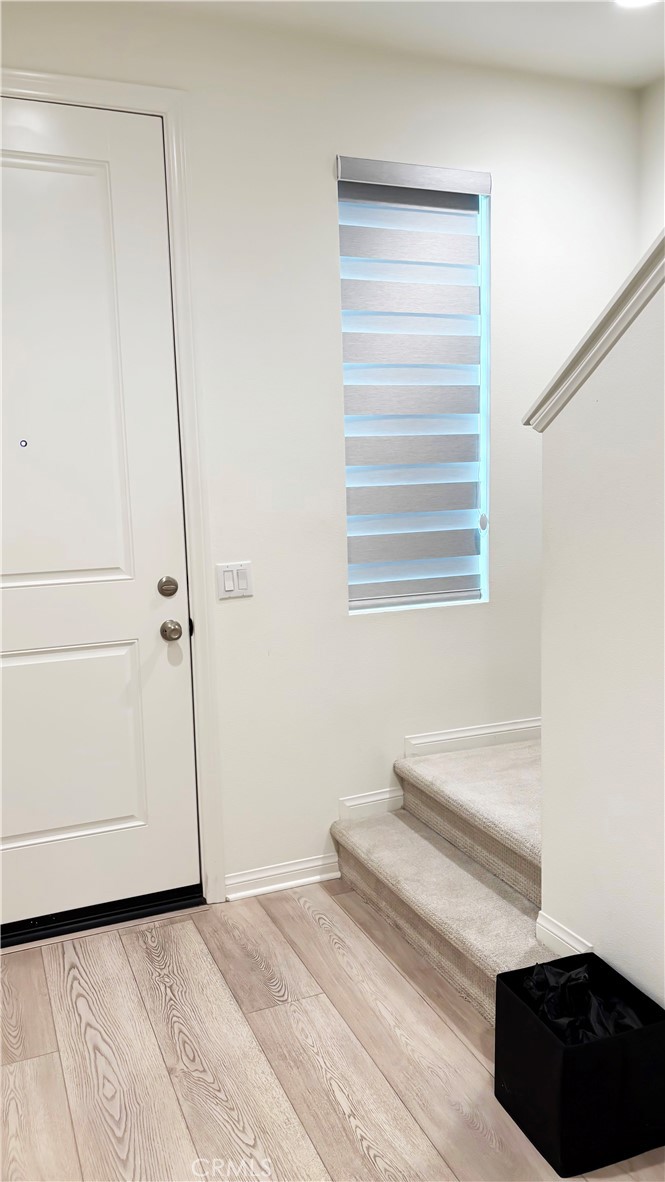 6972 Sagebrush Circle Buena Park, CA 90621 - Photo 3 of 7 a view of a bedroom with wooden floor and white walls