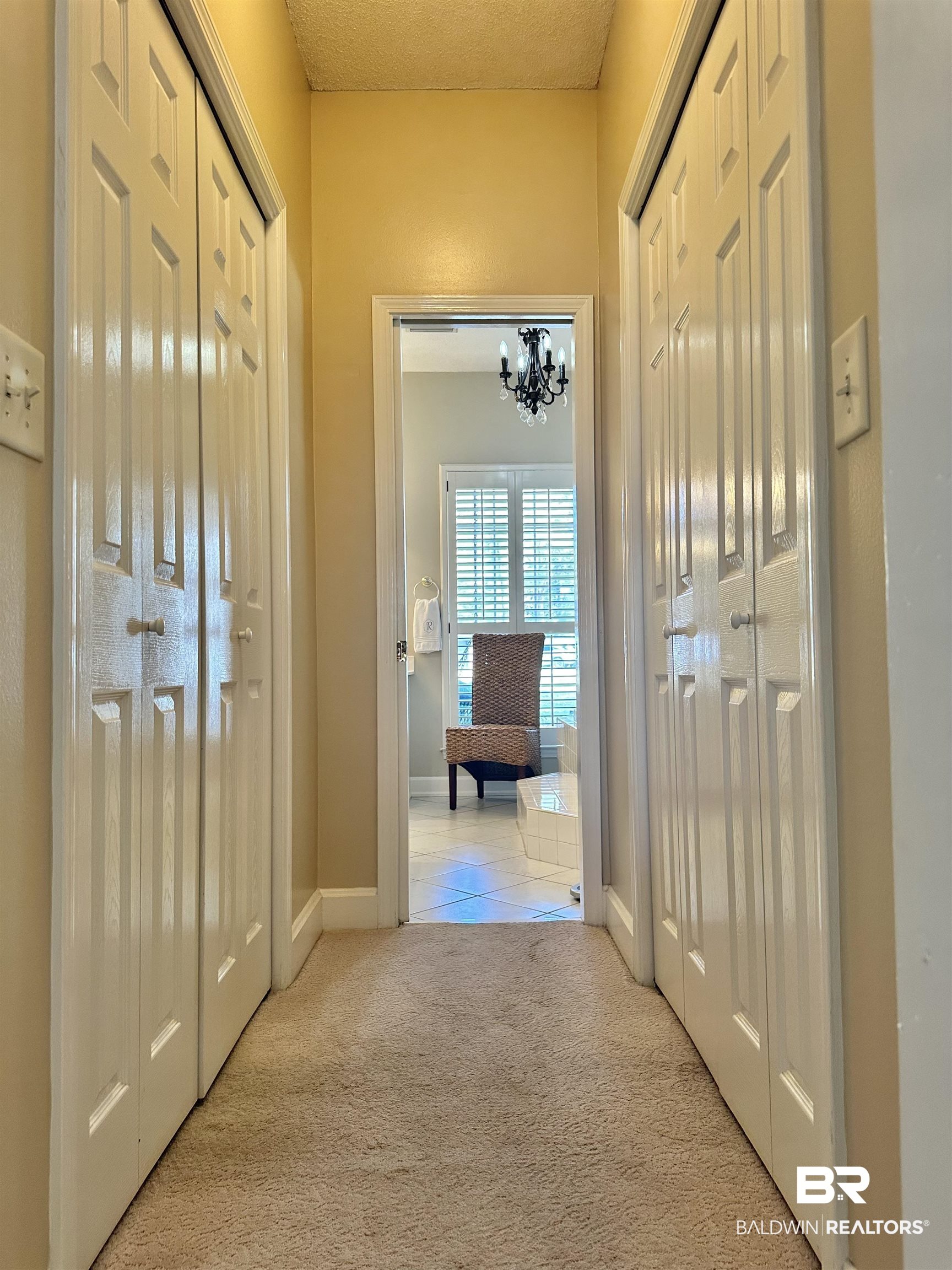 148 Brooks Boulevard Brewton, AL 36426 - Photo 20 of 45 Hall with carpet, baseboards, and a chandelier