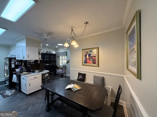 a kitchen with a sink cabinets and wooden floor