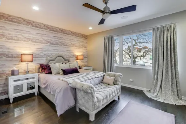 a bedroom with a large bed and a window