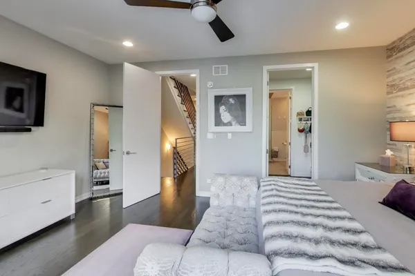 a spacious bedroom with a bed and a couch