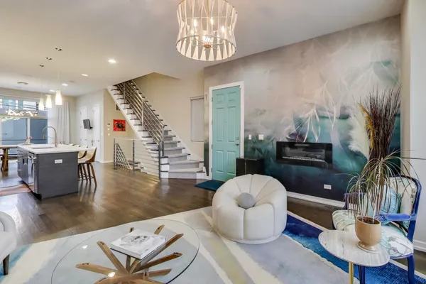 a living room with furniture and a chandelier
