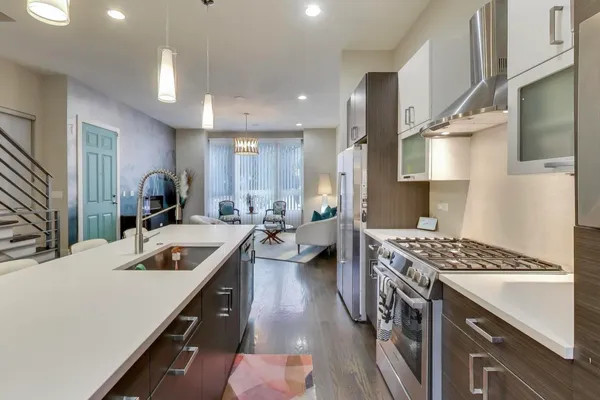a kitchen with counter top space stove and a sink